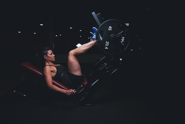 Girl working out on press machine