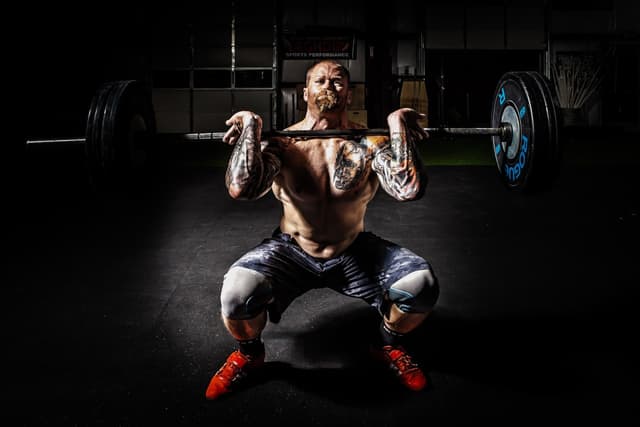 Man doing barbell snatch